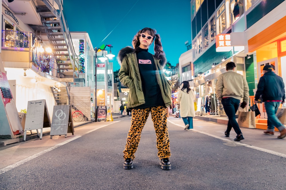 A woman in leopard print jeans posing in the street