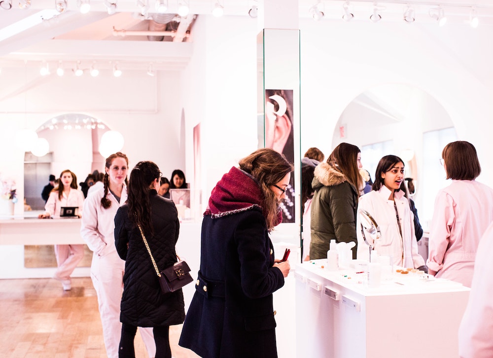 A group of women browsing a high-end fashion brand store.