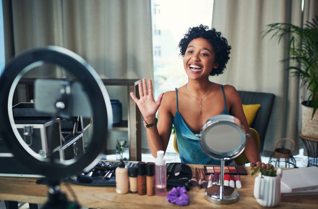 Shot of a influencer recording a makeup tutorial for her blog at home