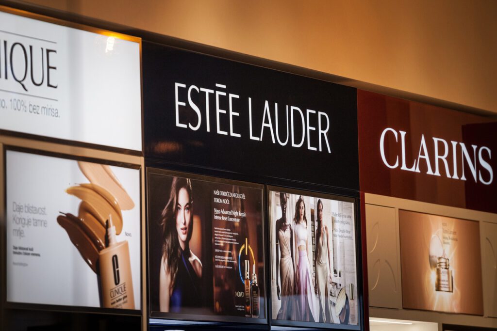 Estee Lauder logo on a shelf of products of the brand. Estee Lauder is an american cosmetics and skincare brand on the luxury market.
