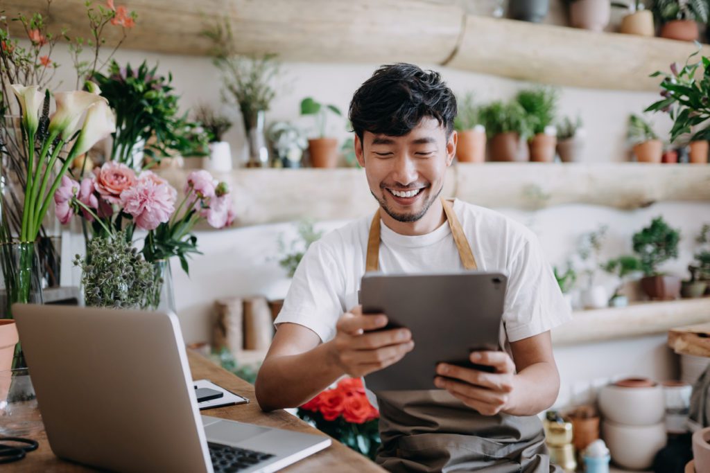 Small business owner smiling at consumer insights data