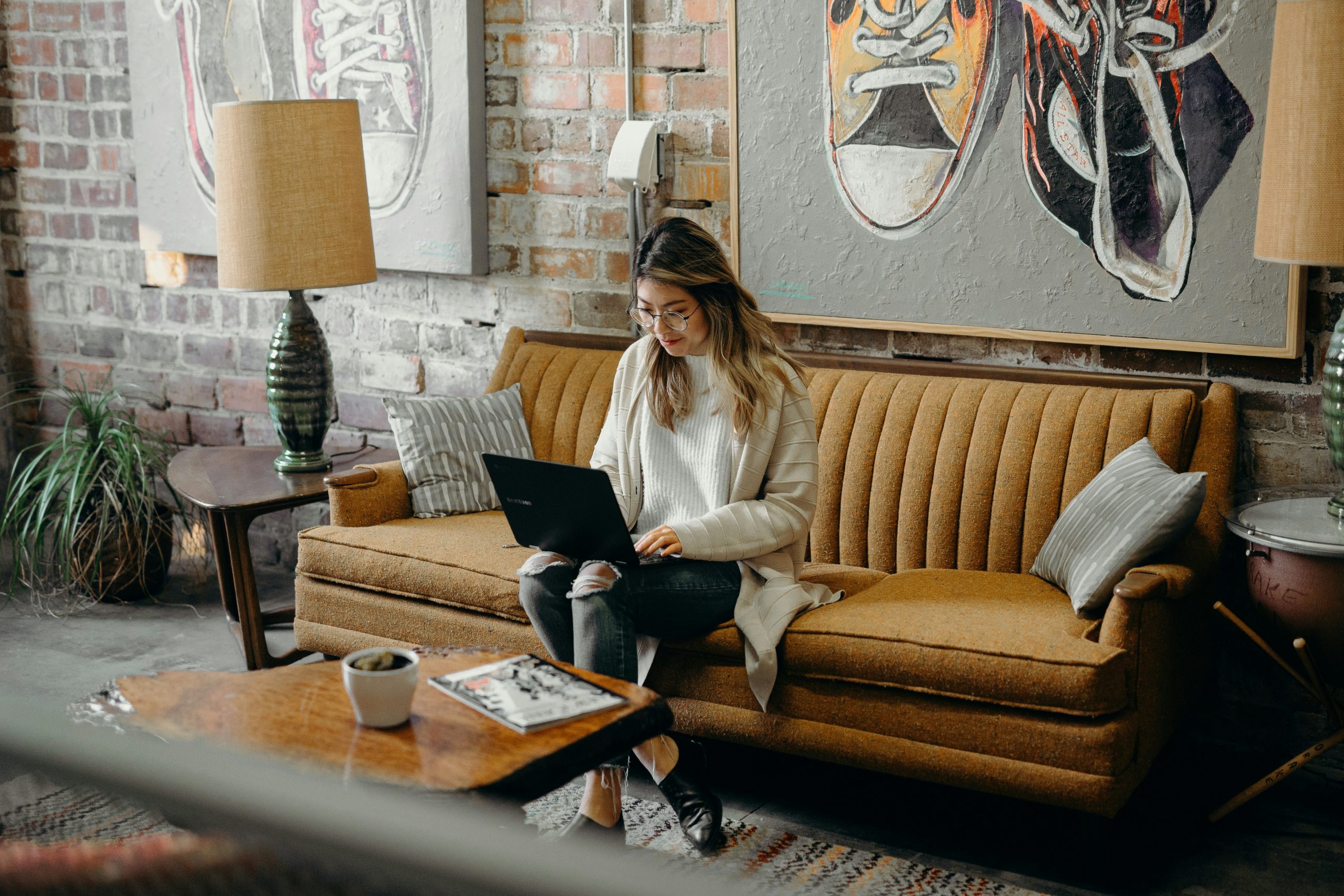 Woman using laptop while sitting on a couch