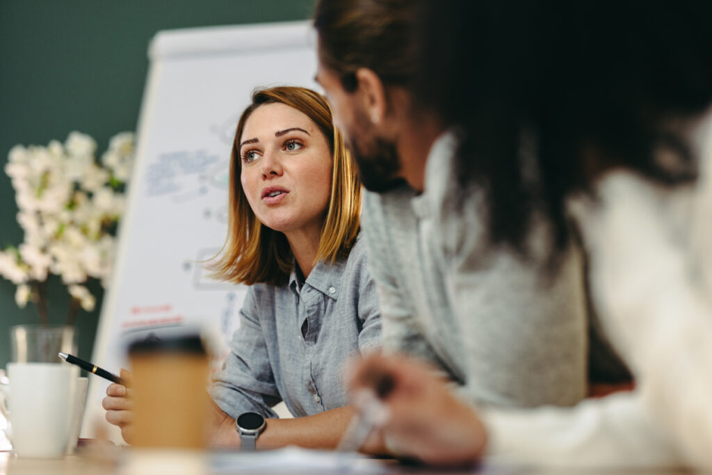 Young businesswoman having a discussion with her colleagues in a boardroom.