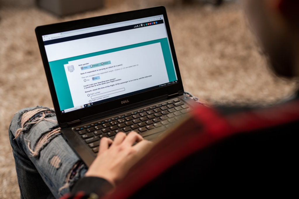 Person sitting at their laptop answering quantitative survey questions