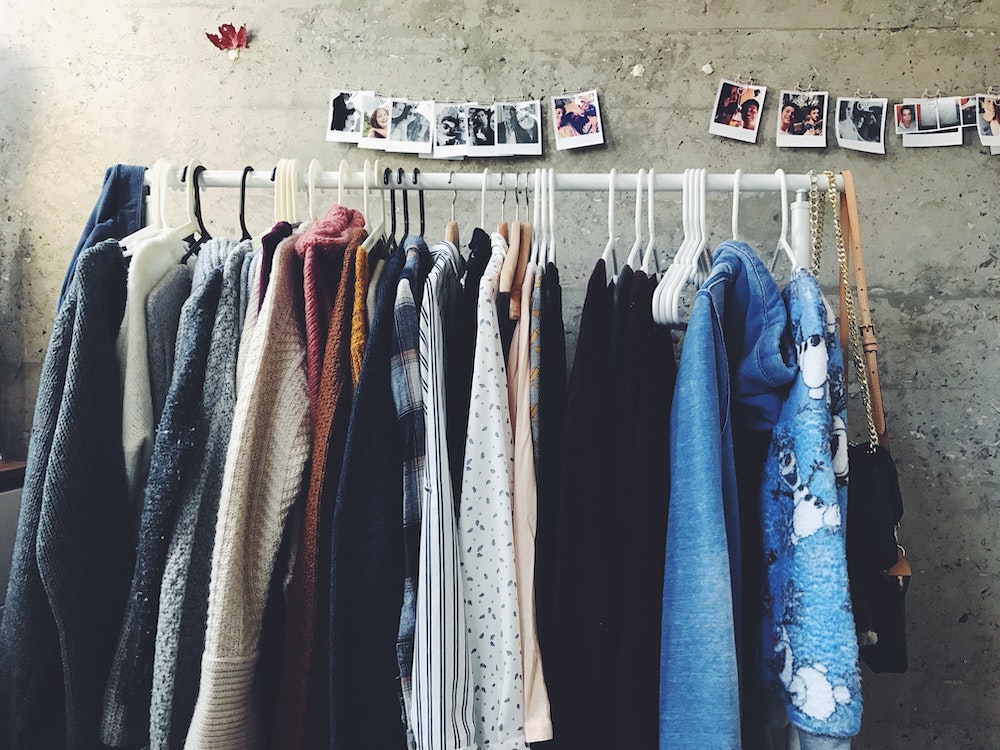 Rack of fashionable clothes designed by a small business owner.