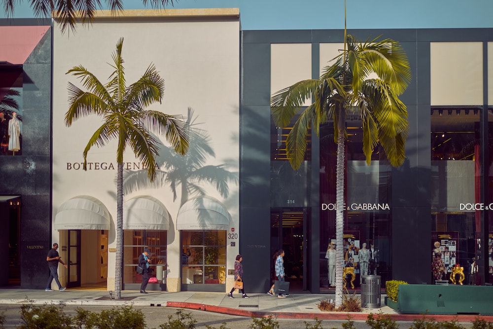 A main street lined with palm trees and fashion brands like Dolce & Gabbana.