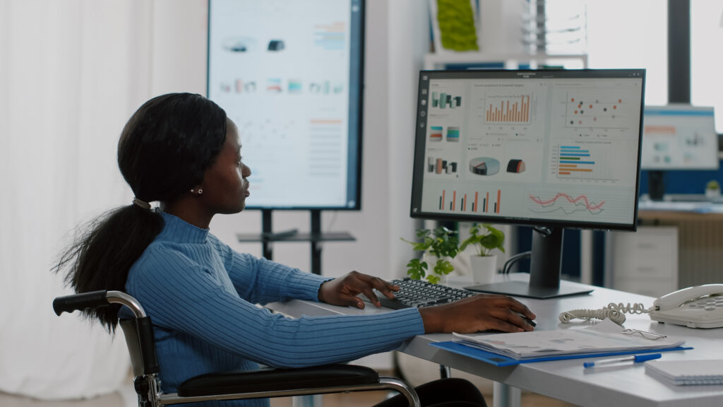 Women working on computer to automate survey analysis and reporting