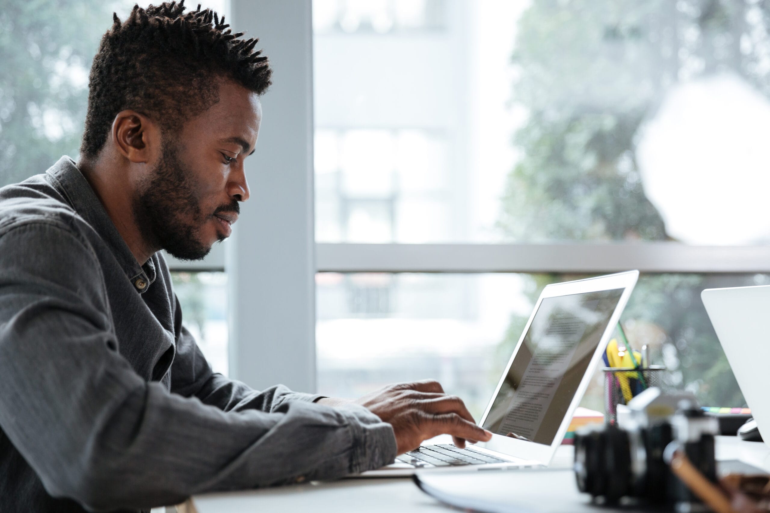 Man working on a computer to detect and remove bots from survey responses